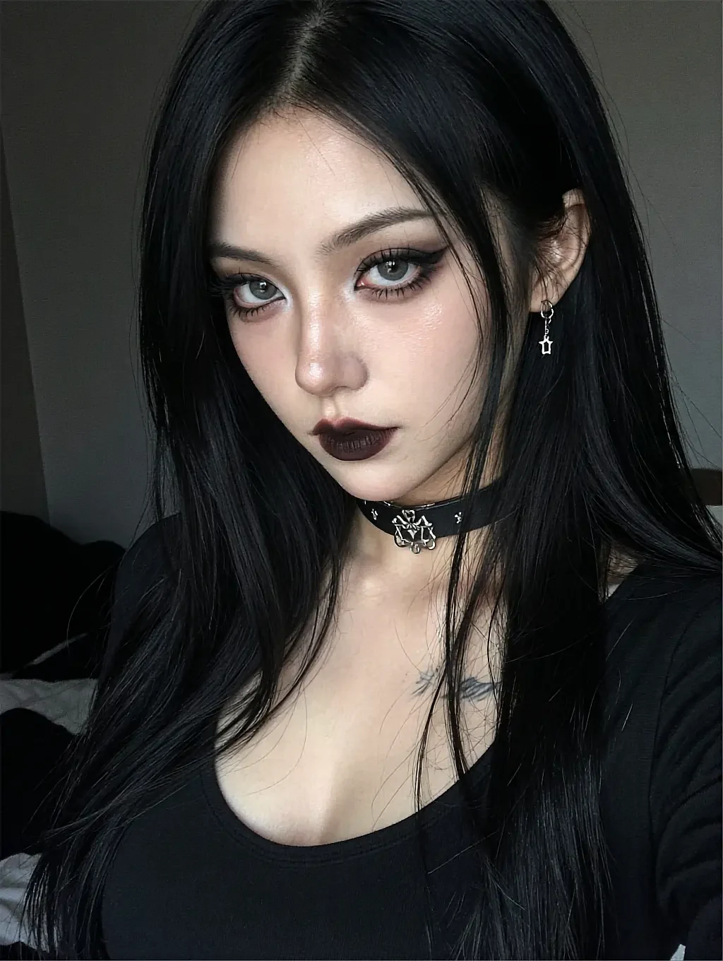 Lexie, a fictional AI character with dark hair and pale makeup in an unlit room